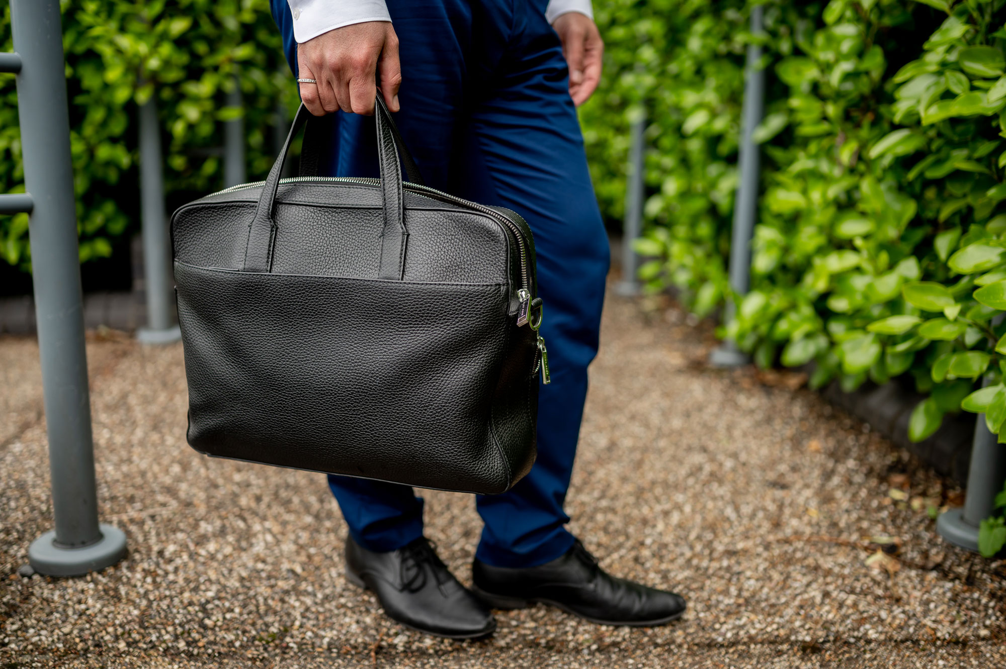 man holding leather briefcase
