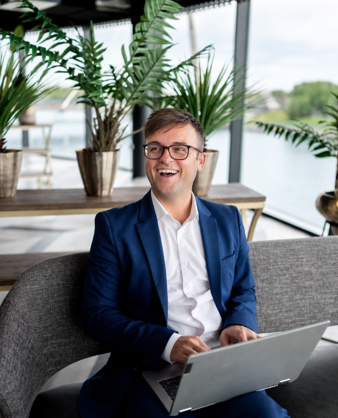 Dan laughing with colleagues in office setting